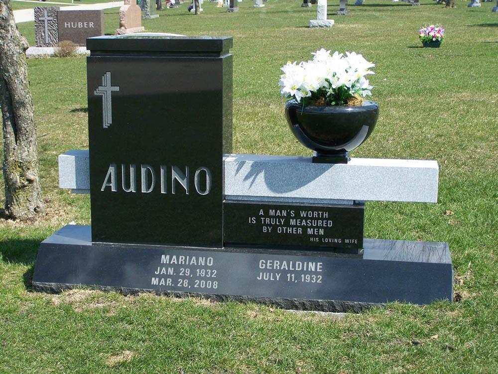 Black and grey family monument with vase and integrated bench
